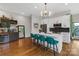 Open concept kitchen with an island, bar stools, stainless steel appliances, and access to an outdoor patio at 2006 Upstate Way, Charlotte, NC 28206