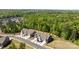 Aerial view of newly constructed townhomes with driveways, grassy lawns, and mature trees at 2034 Suttonview Rd, Fort Mill, SC 29708