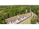 Scenic aerial view of newly built townhomes surrounded by lush greenery and a winding road at 2034 Suttonview Rd, Fort Mill, SC 29708