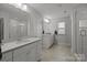 Modern bathroom with dual sinks, white cabinets, and a glass-enclosed shower at 2034 Suttonview Rd, Fort Mill, SC 29708