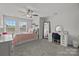 Bright bedroom featuring large windows, ceiling fan, and a stylish desk vanity area at 2034 Suttonview Rd, Fort Mill, SC 29708
