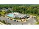 An aerial view of the community center, pool, playground, parking lot, and surrounding mature trees at 2034 Suttonview Rd, Fort Mill, SC 29708