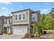 Charming two-story home with a two-car garage and manicured landscaping, set on a sunny day at 2034 Suttonview Rd, Fort Mill, SC 29708