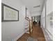 Bright hallway with hardwood floors and stairs leading to the upper level, filled with natural light at 2034 Suttonview Rd, Fort Mill, SC 29708