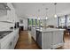 Modern kitchen with white cabinets, stainless steel appliances, and an island overlooking the living area at 2034 Suttonview Rd, Fort Mill, SC 29708