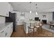 Modern kitchen with white cabinetry, stainless steel appliances, and a large center island with bar seating at 2034 Suttonview Rd, Fort Mill, SC 29708