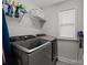 Laundry room with gray tile floors and front loading washer and dryer at 2034 Suttonview Rd, Fort Mill, SC 29708
