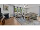 Comfortable living room with a fireplace, sofas, rug, and large windows at 2034 Suttonview Rd, Fort Mill, SC 29708