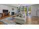 Inviting living room featuring a fireplace, sofas, rug, and a view of the backyard at 2034 Suttonview Rd, Fort Mill, SC 29708