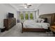 Comfortable main bedroom boasts large windows, tray ceiling, and carpet at 2034 Suttonview Rd, Fort Mill, SC 29708