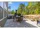 Paver patio with outdoor dining table and chairs, a shady umbrella, and a view of the backyard at 2034 Suttonview Rd, Fort Mill, SC 29708