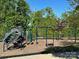 A fun community playground with slides, swings, and climbing structures, surrounded by lush greenery at 2034 Suttonview Rd, Fort Mill, SC 29708