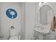 Stylish powder room with a pedestal sink, modern fixtures, and elegant decor at 2034 Suttonview Rd, Fort Mill, SC 29708