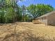 This home's backyard features a wooden deck, newly laid straw, and lush landscaping at 2362 Marett Blvd, Rock Hill, SC 29732