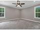 Spacious bedroom with a ceiling fan and two windows that bring in natural light at 2362 Marett Blvd, Rock Hill, SC 29732