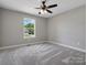A bright bedroom featuring a large window and neutral carpet at 2362 Marett Blvd, Rock Hill, SC 29732