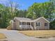 Inviting single-story home with a charming porch, set against a backdrop of lush greenery at 2362 Marett Blvd, Rock Hill, SC 29732