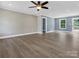 Bright, spacious living room featuring new flooring, fresh paint, and a ceiling fan at 2362 Marett Blvd, Rock Hill, SC 29732