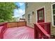 Red painted deck overlooking a backyard with siding and a red door of the home at 2530 Cochrane Dr, Charlotte, NC 28269