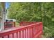 Painted backyard deck overlooking a tree-filled lot near the siding of the home at 2530 Cochrane Dr, Charlotte, NC 28269