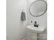Stylish powder room featuring a modern sink with black fixtures and a round mirror at 2530 Cochrane Dr, Charlotte, NC 28269