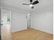A bright bedroom features neutral walls, wood-look floors, and a modern ceiling fan at 2530 Cochrane Dr, Charlotte, NC 28269