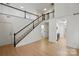 Bright foyer with hardwood floors, staircase, and a view of the upstairs balcony at 2530 Cochrane Dr, Charlotte, NC 28269