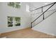 Bright foyer with hardwood floors, staircase, and large windows that flood the space with natural light at 2530 Cochrane Dr, Charlotte, NC 28269