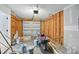 Unfinished garage featuring a metal overhead door, exposed studs, and concrete floors at 2530 Cochrane Dr, Charlotte, NC 28269