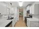 Well-lit kitchen featuring stainless steel appliances, white cabinetry, and ample counter space at 2530 Cochrane Dr, Charlotte, NC 28269