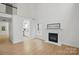 Bright living room featuring hardwood floors, a cozy fireplace, and seamless access to the modern kitchen at 2530 Cochrane Dr, Charlotte, NC 28269