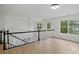 Open loft area with hardwood floors, contemporary light fixtures, and natural light at 2530 Cochrane Dr, Charlotte, NC 28269