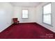 Bedroom with white walls, red carpet, and large windows for natural light at 3012 Morgan Mill Rd, Monroe, NC 28110