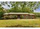 Charming brick ranch-style home with a metal roof, green shutters, and a well-maintained front yard at 3012 Morgan Mill Rd, Monroe, NC 28110