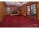 Living room with brick fireplace, exposed beams, and french doors that fill the room with light at 3012 Morgan Mill Rd, Monroe, NC 28110