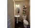 Stylish half bathroom with unique wallpaper, pedestal sink, and modern fixtures at 4203 Flint Dr, Lancaster, SC 29720