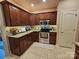 Modern kitchen features stainless steel appliances, tile flooring, and rich wood cabinetry at 4203 Flint Dr, Lancaster, SC 29720