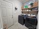 Laundry room with black washer and dryer, decor, and wooden shelves at 4203 Flint Dr, Lancaster, SC 29720