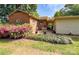 The backyard features a brick home, patio, and lush azalea bushes, creating a private outdoor space at 437 Old Mountain Rd, Statesville, NC 28677
