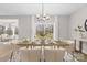 Elegant dining room with modern chandelier, dining table set, and large window with backyard view at 5115 Carden Dr, Charlotte, NC 28227