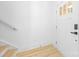 Bright entryway featuring a white door, light wood flooring, and a staircase with a minimalist handrail at 5115 Carden Dr, Charlotte, NC 28227