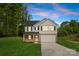 Charming two-story home featuring a brick and white exterior, attached garage, and a well-manicured lawn at 5115 Carden Dr, Charlotte, NC 28227