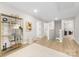 Bright hallway with hardwood floors, modern shelving, and views of multiple rooms creating an open flow at 5115 Carden Dr, Charlotte, NC 28227