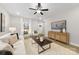 Cozy living room featuring a comfortable sofa, stylish furnishings, ceiling fan and lots of natural light at 5115 Carden Dr, Charlotte, NC 28227