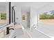 Bright bathroom featuring double sinks, modern fixtures, tub and separate glass shower at 5125 Carden Dr, Charlotte, NC 28227