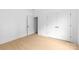 Bright bedroom featuring neutral paint, wood-look floors, closet, and an open door at 5125 Carden Dr, Charlotte, NC 28227