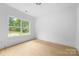 Bright bedroom featuring a large window with natural views at 5125 Carden Dr, Charlotte, NC 28227