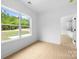 Well lit bedroom features large windows offering natural light and views at 5125 Carden Dr, Charlotte, NC 28227