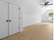 Spacious bedroom with wood-look floors, a ceiling fan, closet, and a large window at 5125 Carden Dr, Charlotte, NC 28227