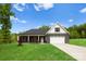 Charming house featuring a well-manicured lawn, black brick, and a two-car garage at 5125 Carden Dr, Charlotte, NC 28227
